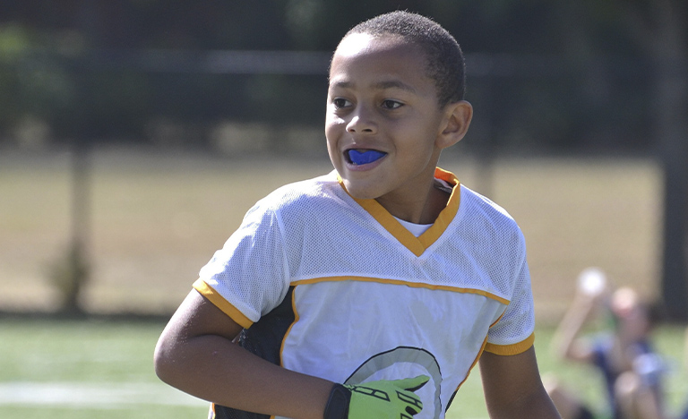 Boy playing sports with mouthguard